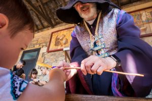 concentrating while making his wand