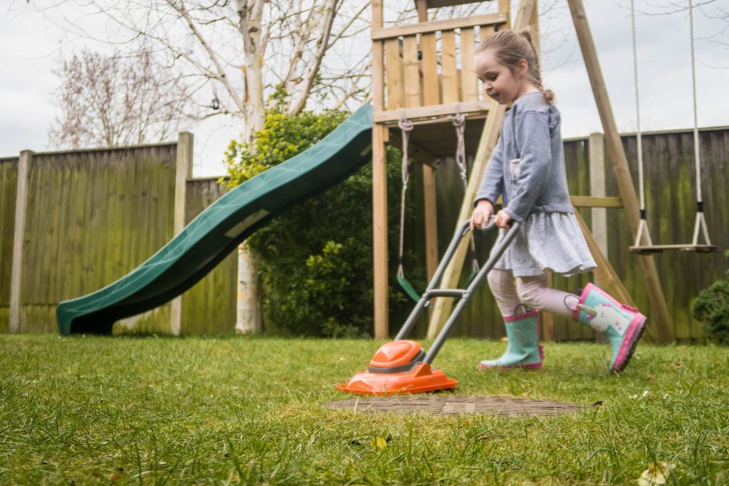 AD Cutting the grass with the Casdon Flymo Lawn Mower