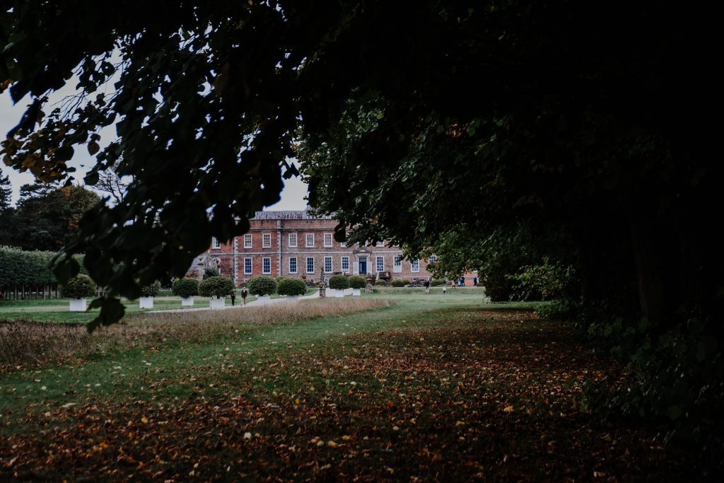 A glimpse of Erddig Hall through the trees