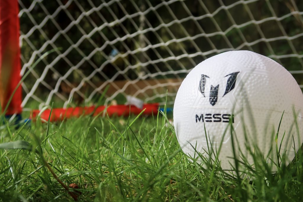 A close up of the Messi ball with the foldable goal in the background